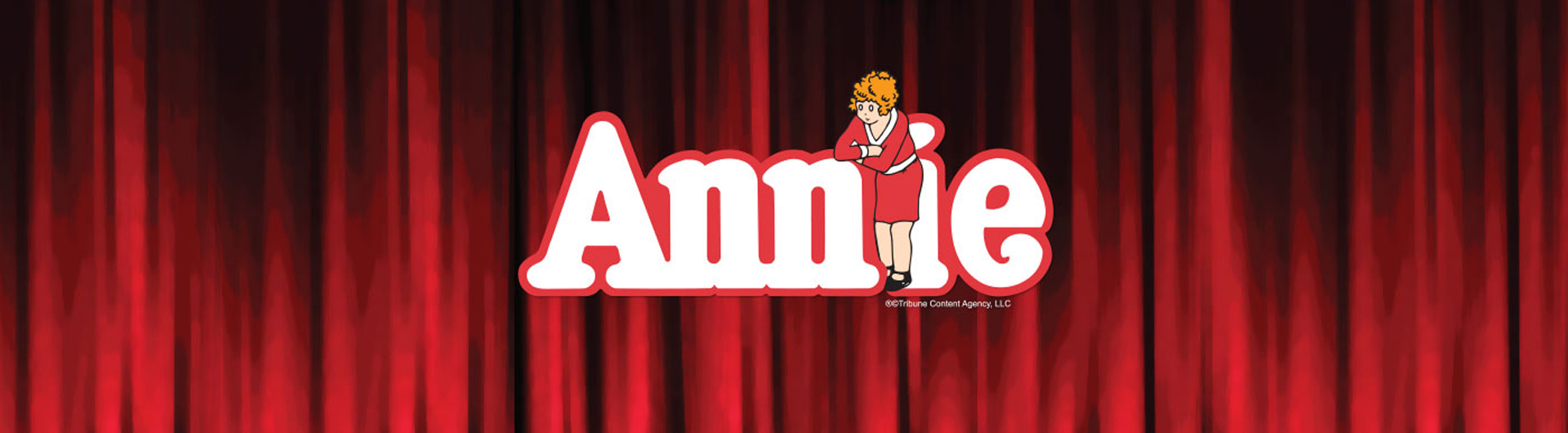 Annie title with cartoon Annie in front of letter i